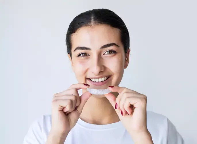 Woman inserting mouth guard